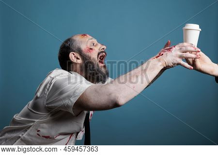 Aggressive Zombie Wishing To Drink Coffee Cup In Studio, Going After Beverage And Wanting To Eat Car
