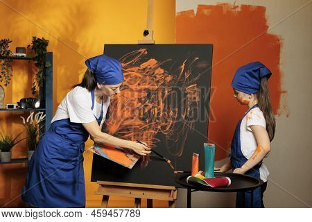 Mom And Daughter Learning To Paint With Aquarelle And Colormix On Canvas, Creating Art Masterpiece W