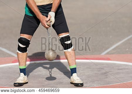 An Athlete Competing In The Hammer Throw Event, Athlete Performing A Hammer Throw In Stadium