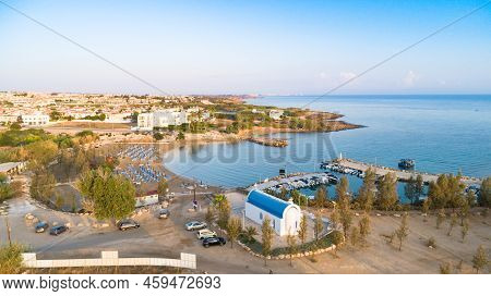 Aerial View Of Coastline Sunset And Landmark White Washed Chapel At Agia Triada Beach, Protaras, Fam