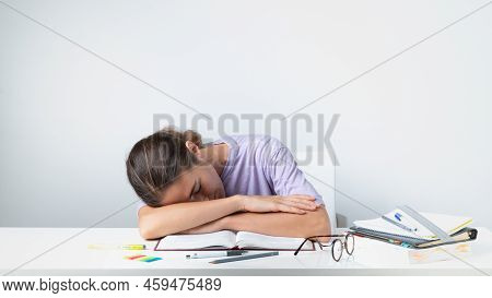 A Tired Student Sleeps On A Notebook On The Table - Before The Exam. High Quality Photo