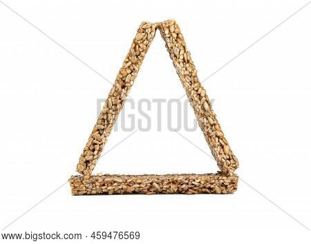 Triangle Of Strips Of Kozinak From Seeds And Molasses On A White Background. Delicious Oriental Swee