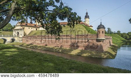 Moat Of Old Castle. Moat With Reflection In The Water And Trees. Sunny Summer Day. Palace, Tower, Co