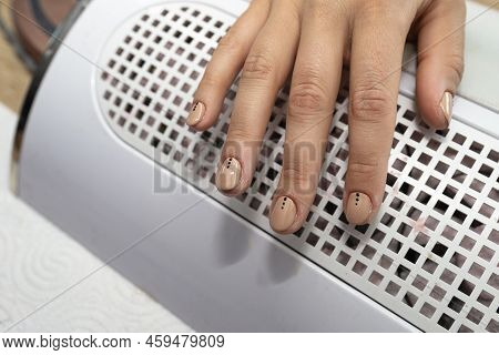 The Manicurist Applies A Topcoat To The Finished Hybrid Nails With A Brush.