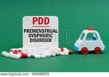 Medical Concept. On A Green Surface, An Ambulance, Pills And A White Sign With The Inscription - Pre