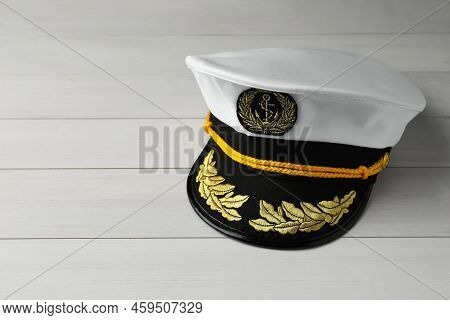 Peaked Cap With Accessories On White Wooden Background, Space For Text