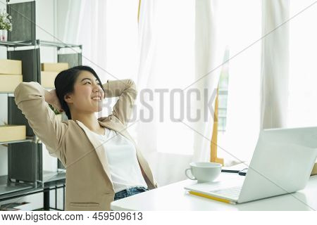Happy Young Asian Female Freelan Sit In Online Clothing Store.