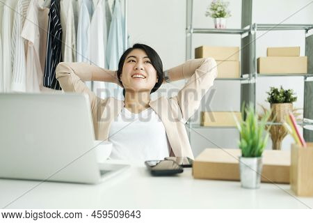 Happy Young Asian Female Freelan Sit In Online Clothing Store.