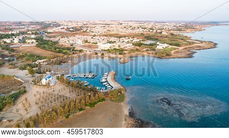 Aerial View Of Coastline Sunset And Landmark White Washed Chapel At Agia Triada Beach, Protaras, Fam