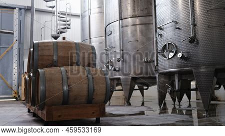 Huge Tanks In Wine Cellars And Wooden Barrels Of Wine Or Alcohol. Production Of Elite Collection Win