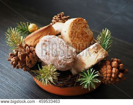 Polvorones, Mantecados, Estepa En Ceramic Bowl. Branches Of A Christmas Tree. Isolated On Black Back