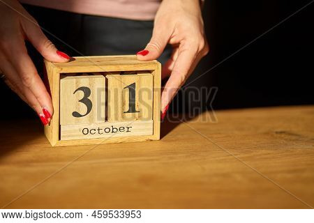 Woman Hand Change, Sets The Date On The Wooden Calendar On 31 October