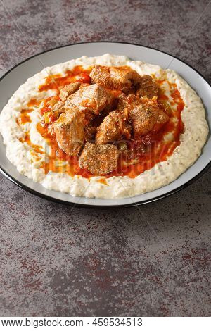 Hunkar Begendi Meat Stew Over Eggplant Sauce Closeup In The Plate On The Table. Vertical