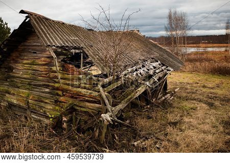 Ruined Old Barn By The River On An Autumn Rainy Day