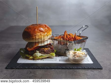 Delicious Hamburger With Fried Eggs And Sweet Potatoes