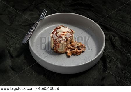 Thai Milk Tea Almond Minibon And Walnuts Served With Metal Fork On Ceramic Plate With Dark Backgroun