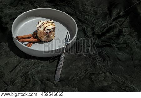 Chocobon (soft Chocolate Bun) Topped With Rich Cream Cheese Frosting And Cinnamon Served With Metal 