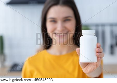 Happy Young Woman Holding Bottle Of Dietary Supplements Or Vitamins In Her Hands Healthy Lifestyle
