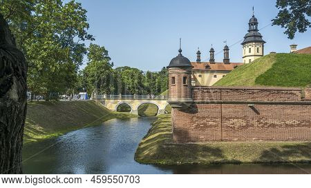 Moat Of Old Castle. Moat With Reflection In The Water And Trees. Sunny Summer Day. Palace, Tower, Co