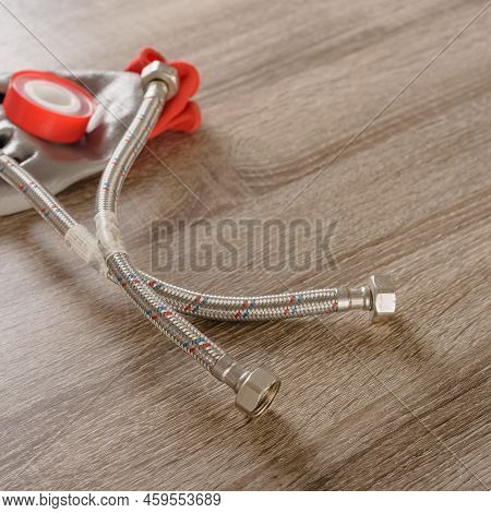 Tube, Tape Fum And Work Gloves On Wooden Background, Closeup Photo