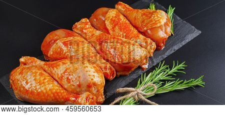 Baner.barbeque Marinated Chicken Dramsticks On A Black Cooking Board On A Black Background With Fres