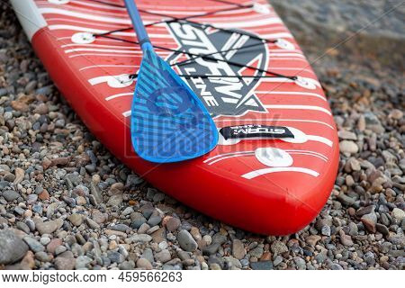 12.07.2022 Krasnoyarsk, Russia. Red Sup Board On The River Bank. Paddle Board On The Lake Shore. Sup