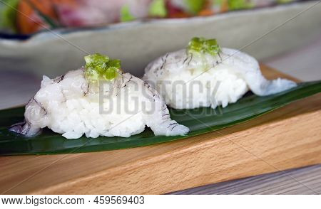Shako Sushi Topping With Wasabi Pickled Served On Wooden Plate Decorated With Bamboo Leaf.