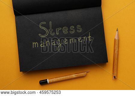 Notebook With Text Stress Management And Broken Pencil On Orange Background, Flat Lay