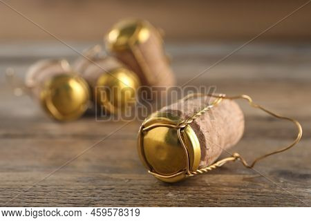 Cork Of Sparkling Wine And Muselet Cap On Wooden Table, Closeup. Space For Text