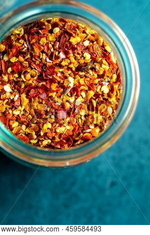 Dried Red Chillies in a Jar on a Blue Background