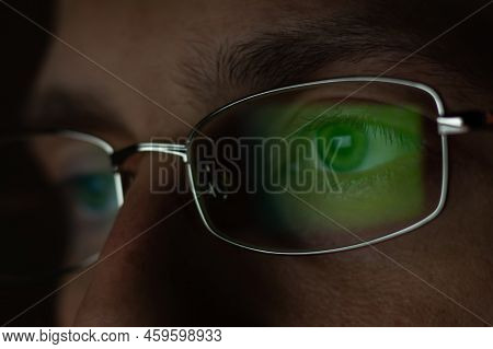 Close Up View Of Man Wears Computer Glasses For Reducing Eye Strain Blurred Vision Looking At Pc Scr