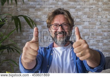 Portrait Of Cheerful Mature Man In Eyeglasses Giving Approval Or Appreciations Sign By Gesturing Thu