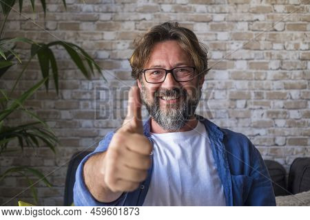 Portrait Of Cheerful Mature Man In Eyeglasses Giving Approval Or Appreciations Sign By Gesturing Thu