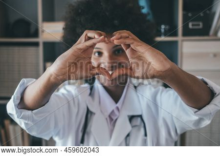 Woman Doing Heart Shape Gesture With Hands. Smiling Black Female Doctor Making A Love Symbol Using H