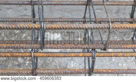 Rusty Metal Reinforcement Bars At Construction Site - From Above Of Weathered Solid Metal Armature R