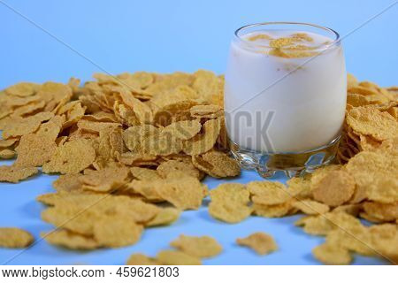 Side View Of Corn Flakes In A Glass Of Milk