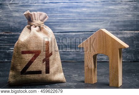 Wooden House And A Polish Zloty Money Bag. Home Purchase, Investment In Real Estate Construction. Ho
