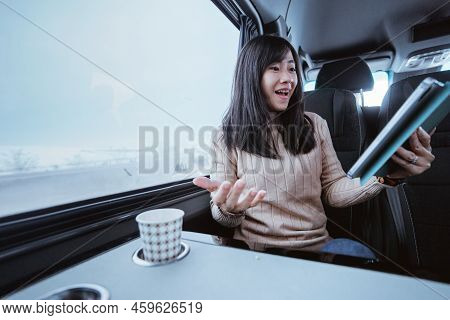 Suprised Young Woman Cover Her Mouth While Looking At Her Mobile Phone