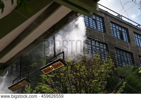 Fogging Outdoor Cool Misting System Working Hot Summer Day For Terrace In Cafe. Facility That Lowers