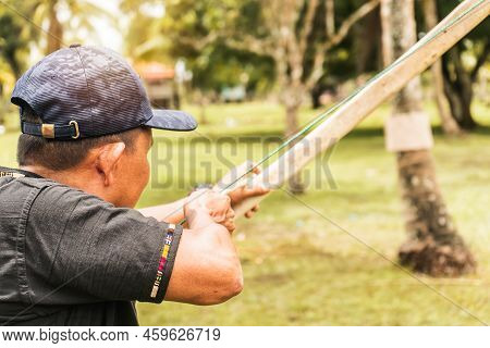 Indigenous Older Adult Aiming At A Target With His Bow And Arrow In The Northern Caribbean Of Nicara