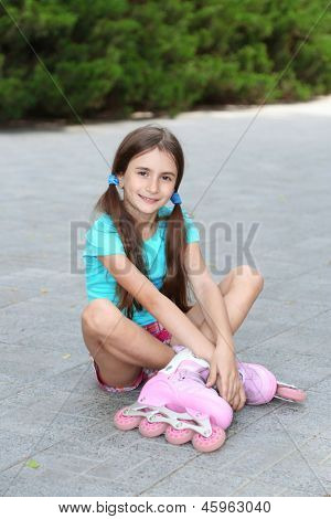 Little girl in roller skates at  park