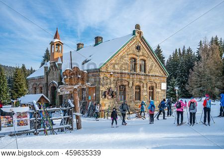 Orle, Poland - January 16, 2022: Historical Tourist Hut On Sunny Winter Day With Cross-country Skier