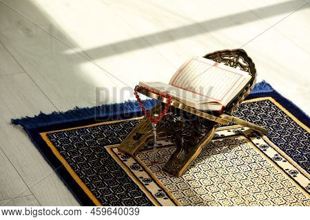 Rehal With Open Quran And Misbaha On Muslim Prayer Rug Indoors, Space For Text