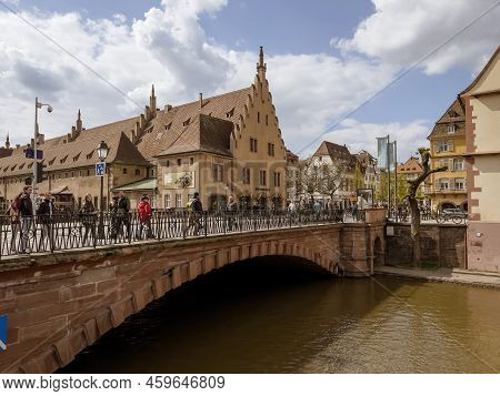 Strasbourg, France - Apr 10, 2022: Pedestrians Walking On The Pont Du Corbeau Bridge And Ancienne Do