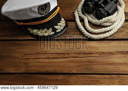 Peaked Cap And Rope With Binoculars On Wooden Background, Space For Text