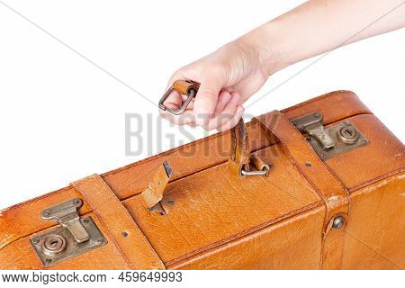 A Suitcase With A Torn Handle. A Human Hand Holds On To The Torn Off Handle Of A Suitcase. Broken Su