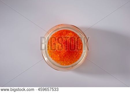 Side View Of Closed Glass Jar With Red Caviar Of Pink Salmon Isolated On White Background.