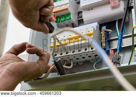 Fastening Circuit Breakers To Din Rail Of Consumer Unit Of Electrical Panel. Mounting Fuse Box For D