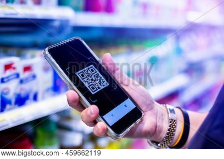 Qr Code Tag On Smartphone With Blurry Products On Shelves In Supermarkets. Scan The Qr Code With Mob