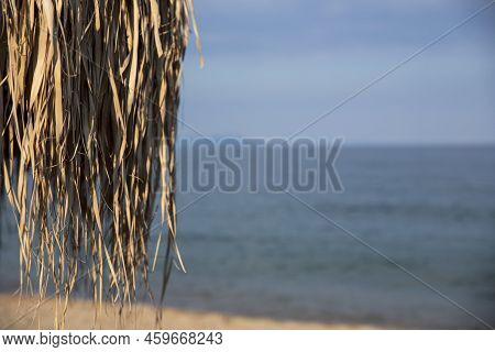 Umbrella Made From Palm Tree Leaves At The Beach